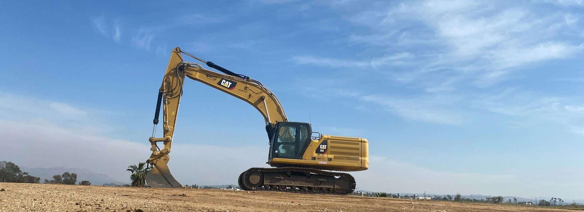Modern Komatsu excavator on an Australian construction site at sunset
